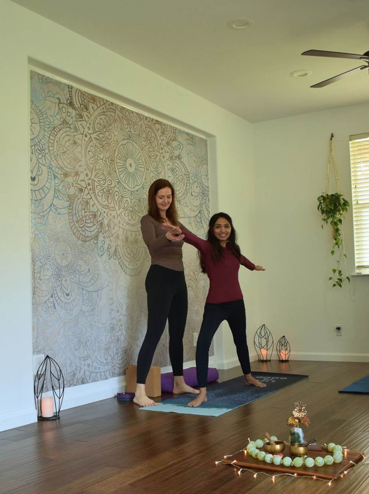 Simona assists a yoga student during private instruction in Mountain House