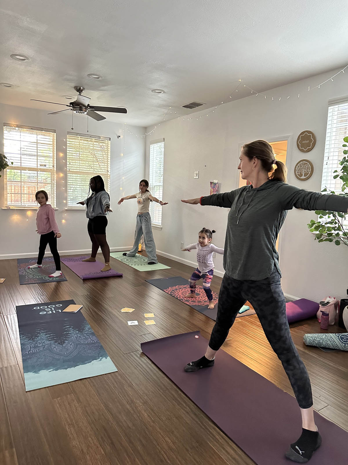 Simona and children practice yoga inside studio in Mountain House
