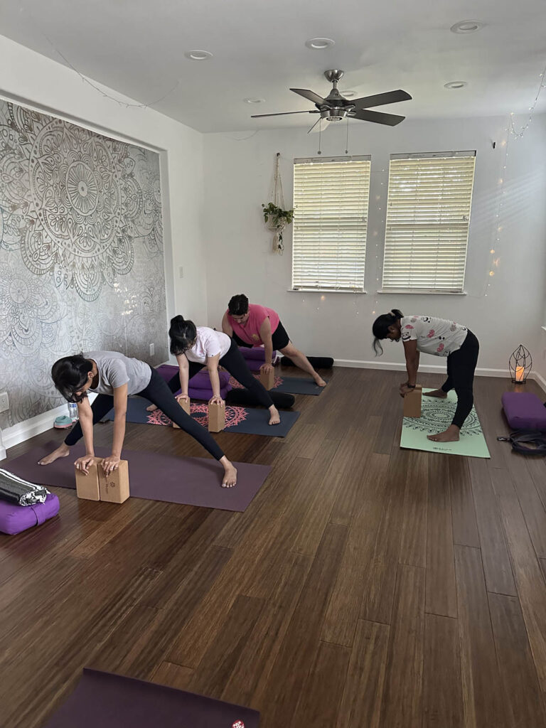 Yoga students in Mountain House use blocks during yoga session