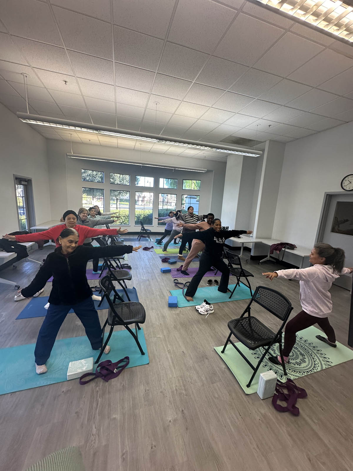 Group of 55+ seniors practicing chair yoga in Mountain House